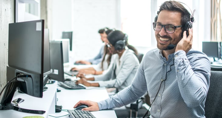 Smiling-handsome-customer-support-operator-with-headset-working-in-call-center--925689786_1258x838